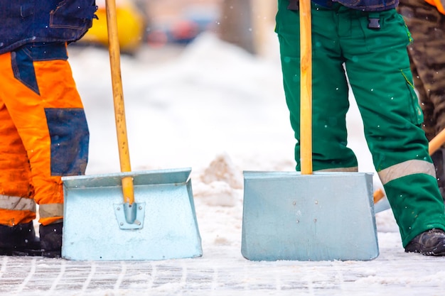 Communal services workers sweep snow from road in winter, Cleaning city streets and roads during snowstorm. Moscow, Russia.