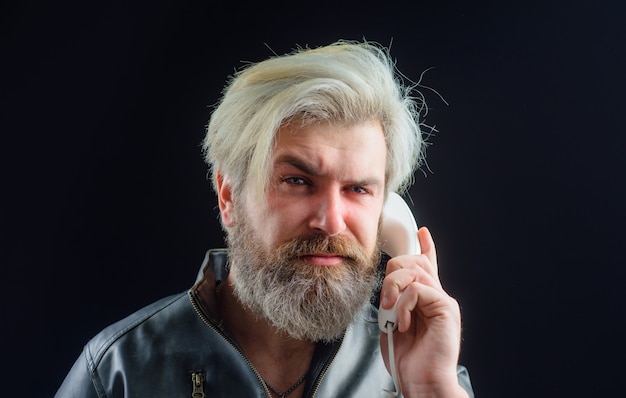 Communication bearded man with handset male talking on landline phone serious man talking on retro