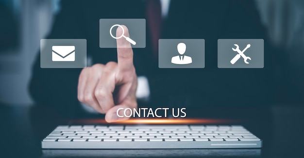 Communication and Contact us or Customer support hotline people connect Hand using a laptop and touching on virtual screen contact icons email and address live chat with internet wifi