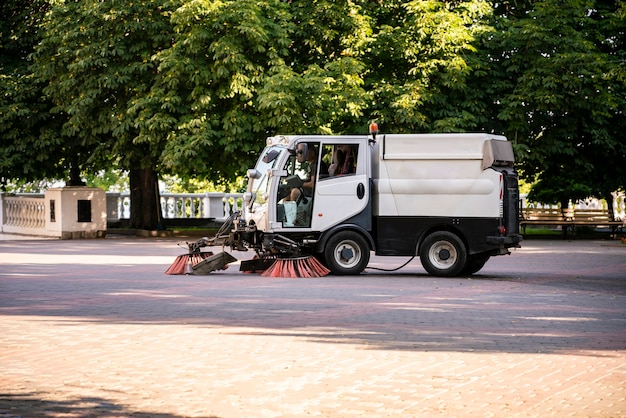 A compact small washing machine in the  city street, municipal sweeper