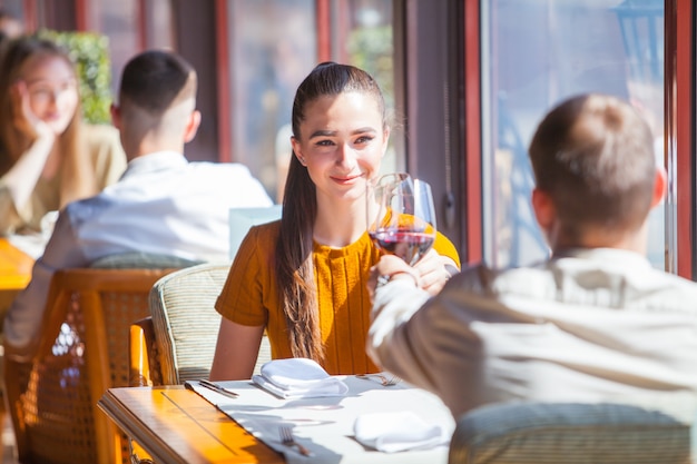 Company of friends celebrates meeting in a restaurant.