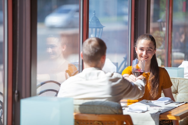 Company of friends celebrates meeting in a restaurant.