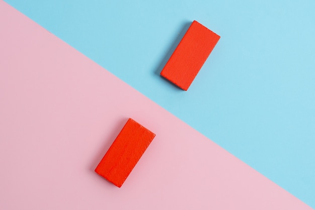 Comparison of Two Objects Blocks Pencils Sticker Notes Facing Inward Outward Making An Arrangement Reflection On a Separated Coloured Background Shot In A Flat Lay Perspective