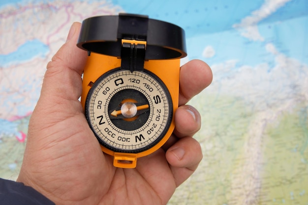 Compass in hand on a map background