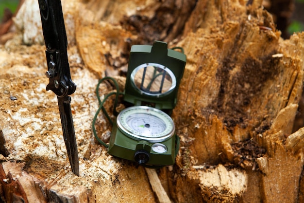 Compass and knife on wood