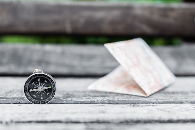 Photo compass and map on a beautiful wooden surface. top view