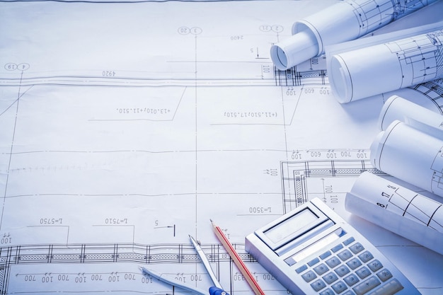 Compass pencil calculator rolled blueprints with big place for text construction concept