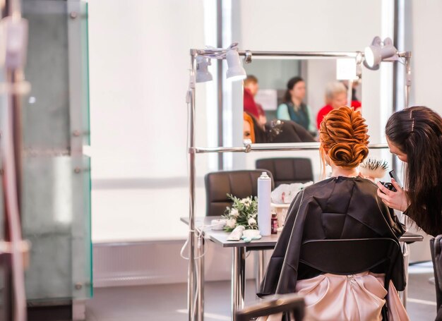 Competition stylists hairdressers at the exhibition of hairstyles and makeup Hairdressers create hairstyles for their models