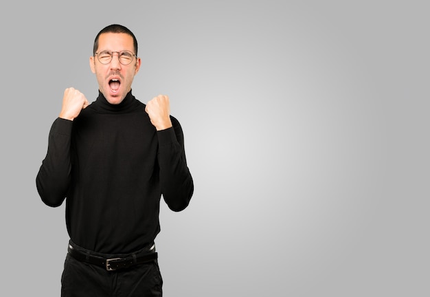 Competitive young man making a gesture of celebration