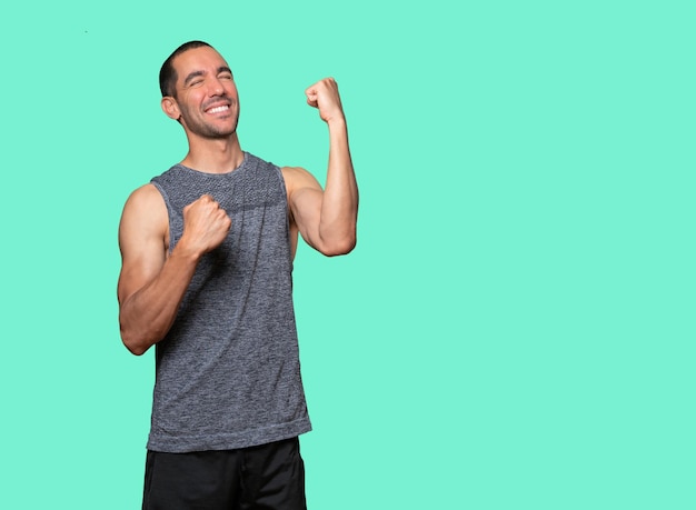 Competitive young man making a gesture of celebration