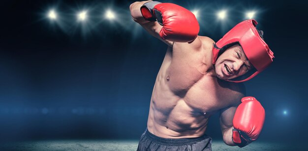 Composite image of aggressive boxer against black background