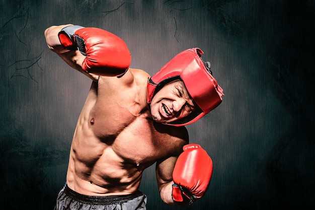 Composite image of aggressive boxer against black background