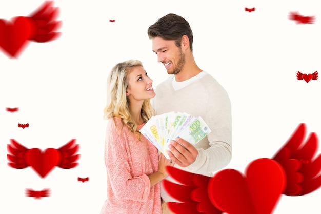 Composite image of attractive couple flashing their cash