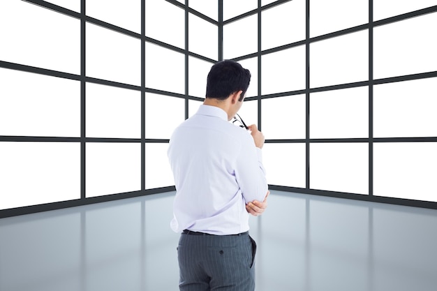 Composite image of businessman holding glasses