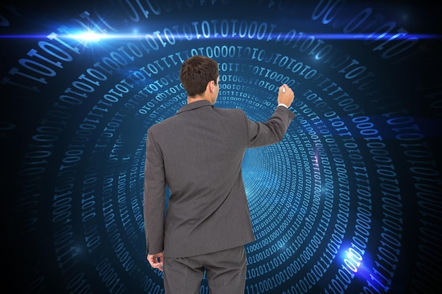 Composite image of businessman standing back to camera writing with marker