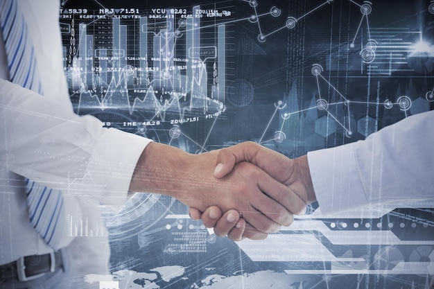 Composite image of closeup shot of a handshake in office