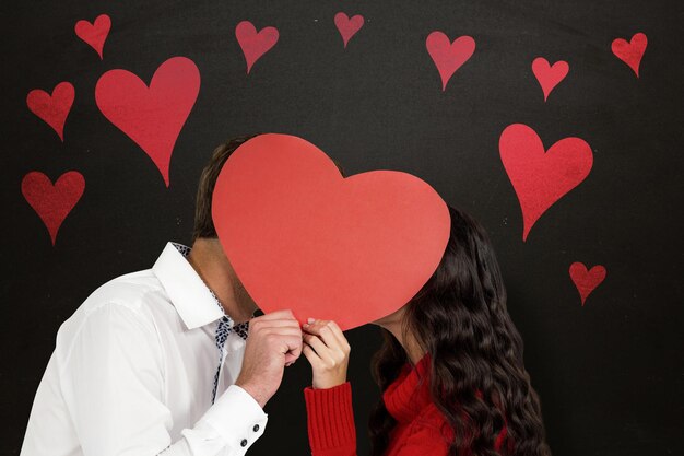 Photo composite image of couple covering faces with paper heart