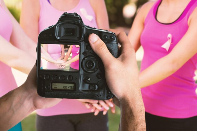 Photo composite image of cropped image of hands holding camera