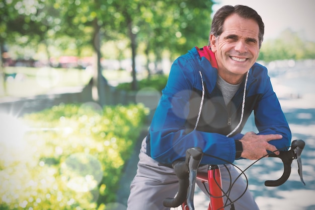 Composite image of digital composite of senior man with his bike