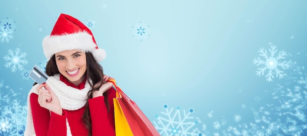 Composite image of excited brunette holding shopping bags and credit card