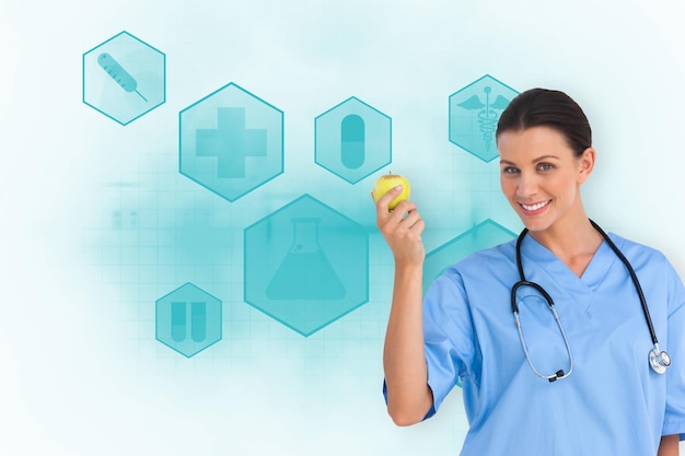 Composite image of happy surgeon holding an apple and smiling at camera