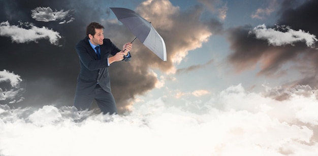 Composite image of man holding umbrella to protect himself from the rain