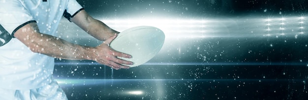 Composite image of midsection of rugby player holding the ball