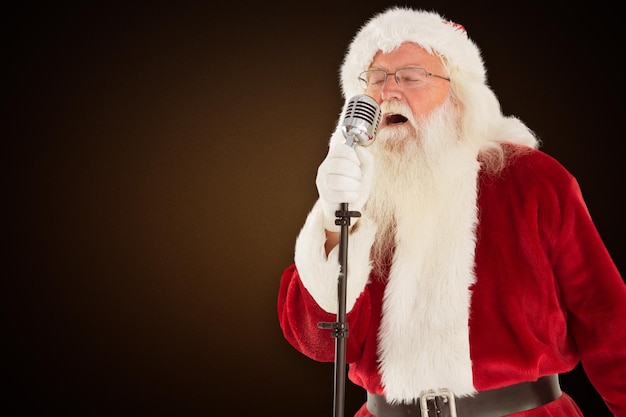 Composite image of santa claus is singing christmas songs