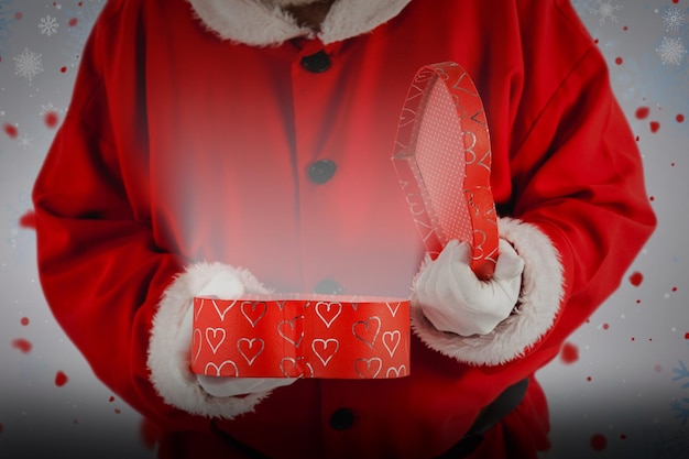 Composite image of santa claus opening a gift box