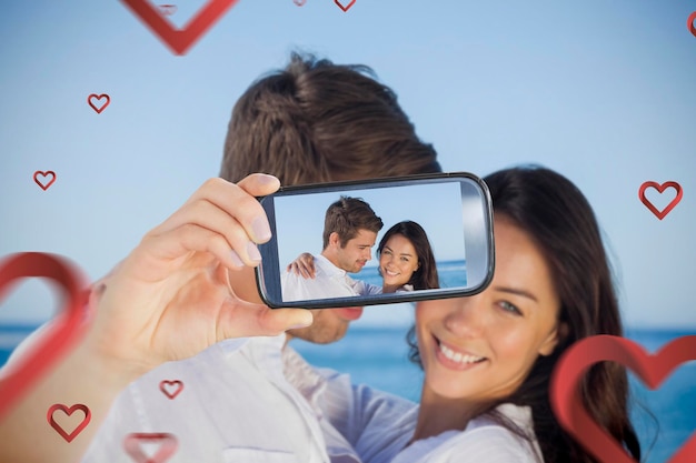 Composite image of valentines couple taking a selfie