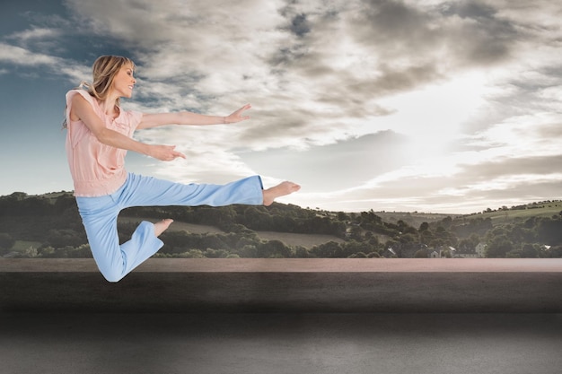 Composite image of woman doing dance pose