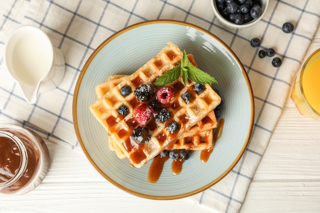 Composition of breakfast with belgian waffles