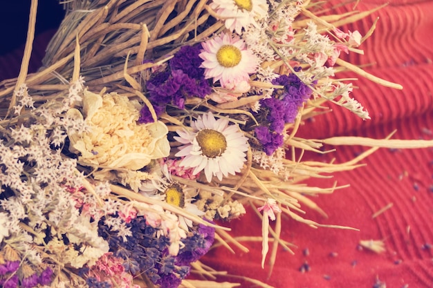 Composition of chamomile purple flowers on a fabric background