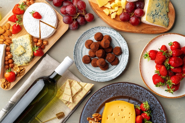 Composition of cheese, and fruits on gray table