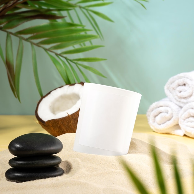 Composition of coconut wax candles and SPA accessories on the beach sand A trendy concept of a tropical scented candle coconut and beach towel Aromatherapy fragrance eco relaxation still life