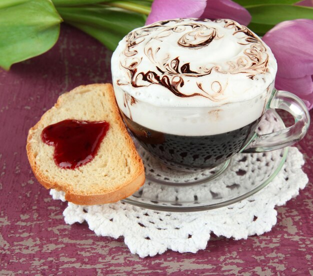 Composition of coffee toast and tulips on color background