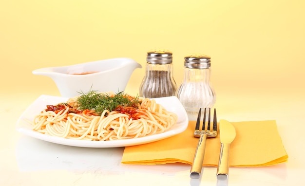 composition of delicious cooked spaghetti with tomato sauce on bright colorful background