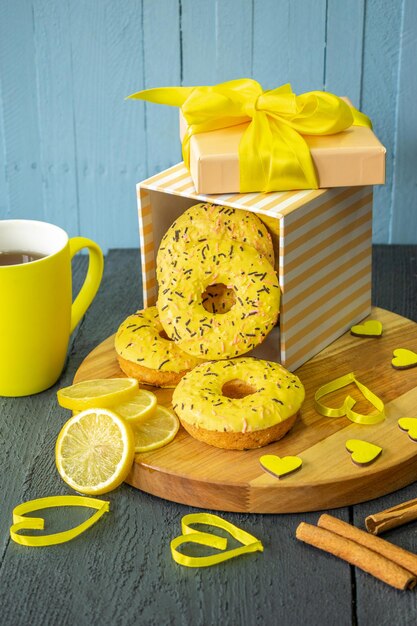 composition of festive breakfast tea and donuts on a wooden background valentine day