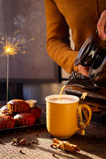 The composition of hand pours cocoa on festive atmosphere