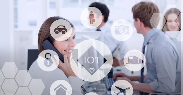 Composition of iot icon with network of connections over businesswoman talking on phone