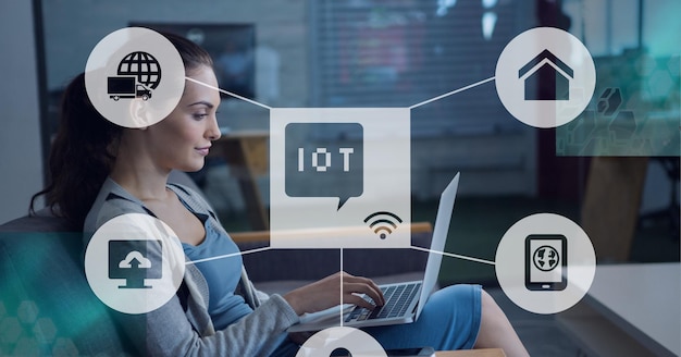 Composition of iot icon with network of connections over woman using laptop