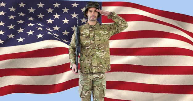 Composition of male soldier saluting over american flag