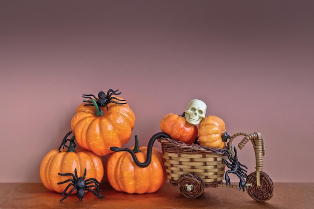 Composition of pumpkins spiders and snakes with a human skull