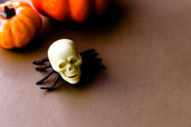 Composition of pumpkins spiders with a human skull