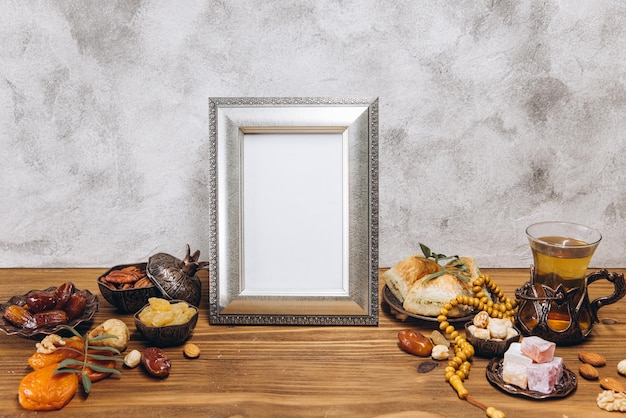 Composition for Ramadan Silver frame with copy space or mockup near traditional islamic tableware