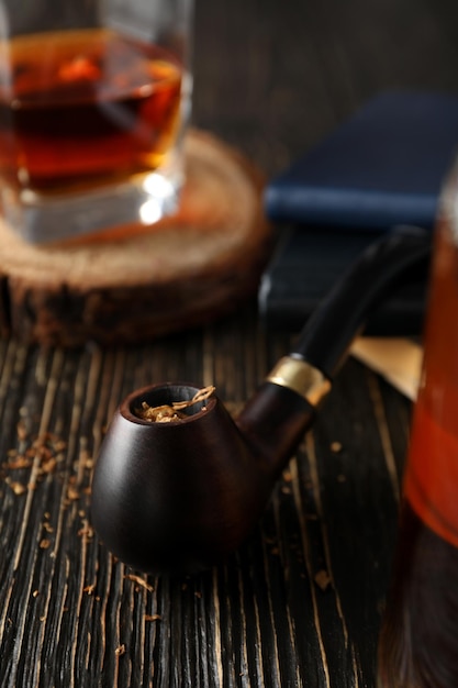 Composition of relaxation with smoking tobacco with smoking pipe on wooden table