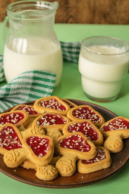 composition of rustic breakfast milk in a jug and cookies a glass of milk on a wooden background