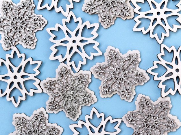 Composition of snowflakes on blue pastel table with copy space