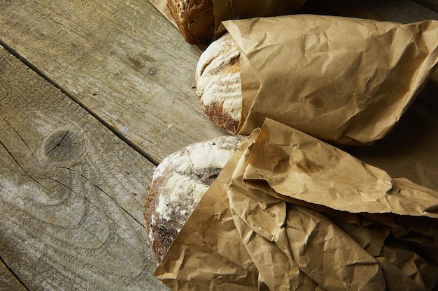 Composition of various breads on wooden background