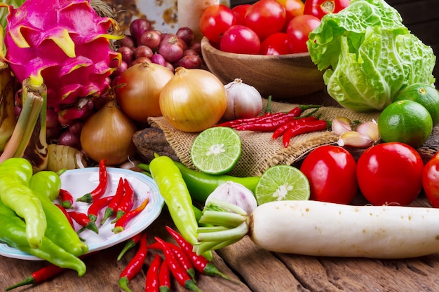 Composition with assorted raw organic vegetables on old wooden table